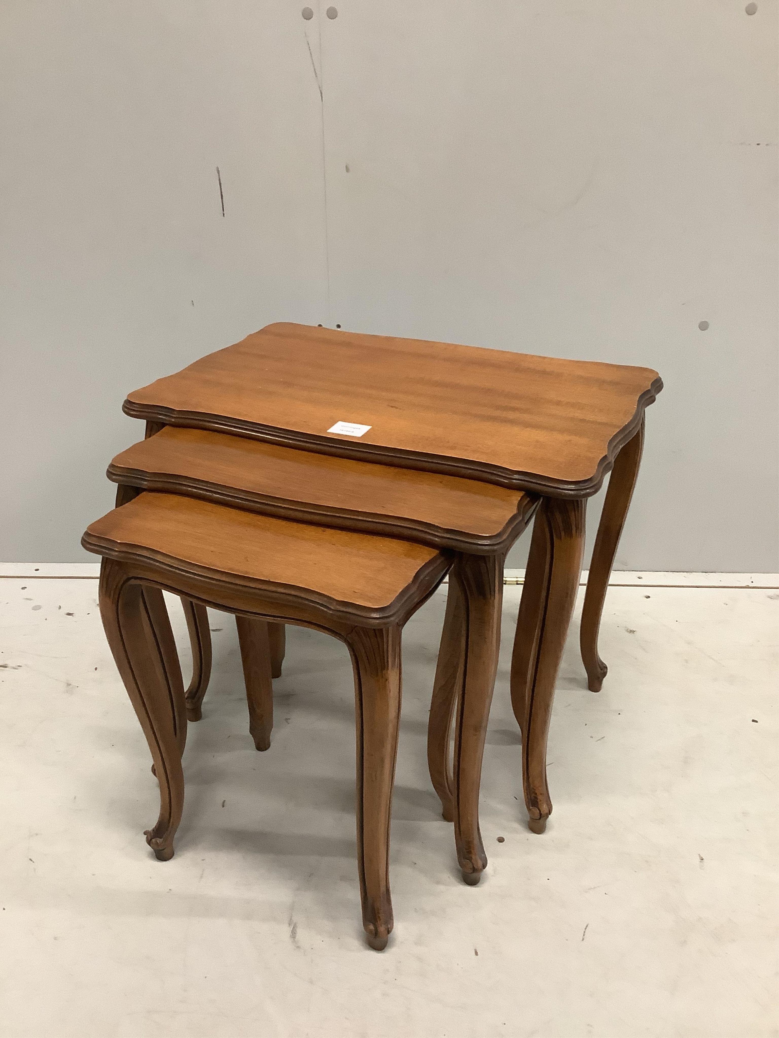 A nest of three mahogany tea tables, on slender cabriole legs, width 58cm, depth 38cm, height 49cm. Condition - good